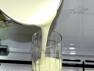 Pouring homemade yogurt into glass