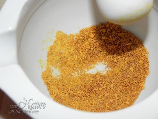 Grinding orange zest powder using mortar and pestle