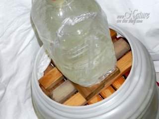 Wooden planks weighed by large bottle of water