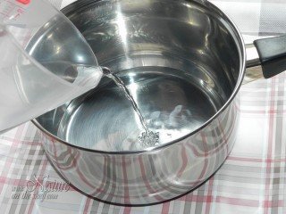 Pouring distilled water into heat proof container